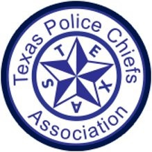 The Texas Police Chiefs Association logo is circular and in a navy blue color. Positioned at the center of the logo is a prominent star, also in navy blue. The letters T-E-X-A-S are arranged around the shape of the star in an opening space between five points. Encircling the star and lettering, the text "Texas Police Chiefs Association" is displayed and forms a complete circle.