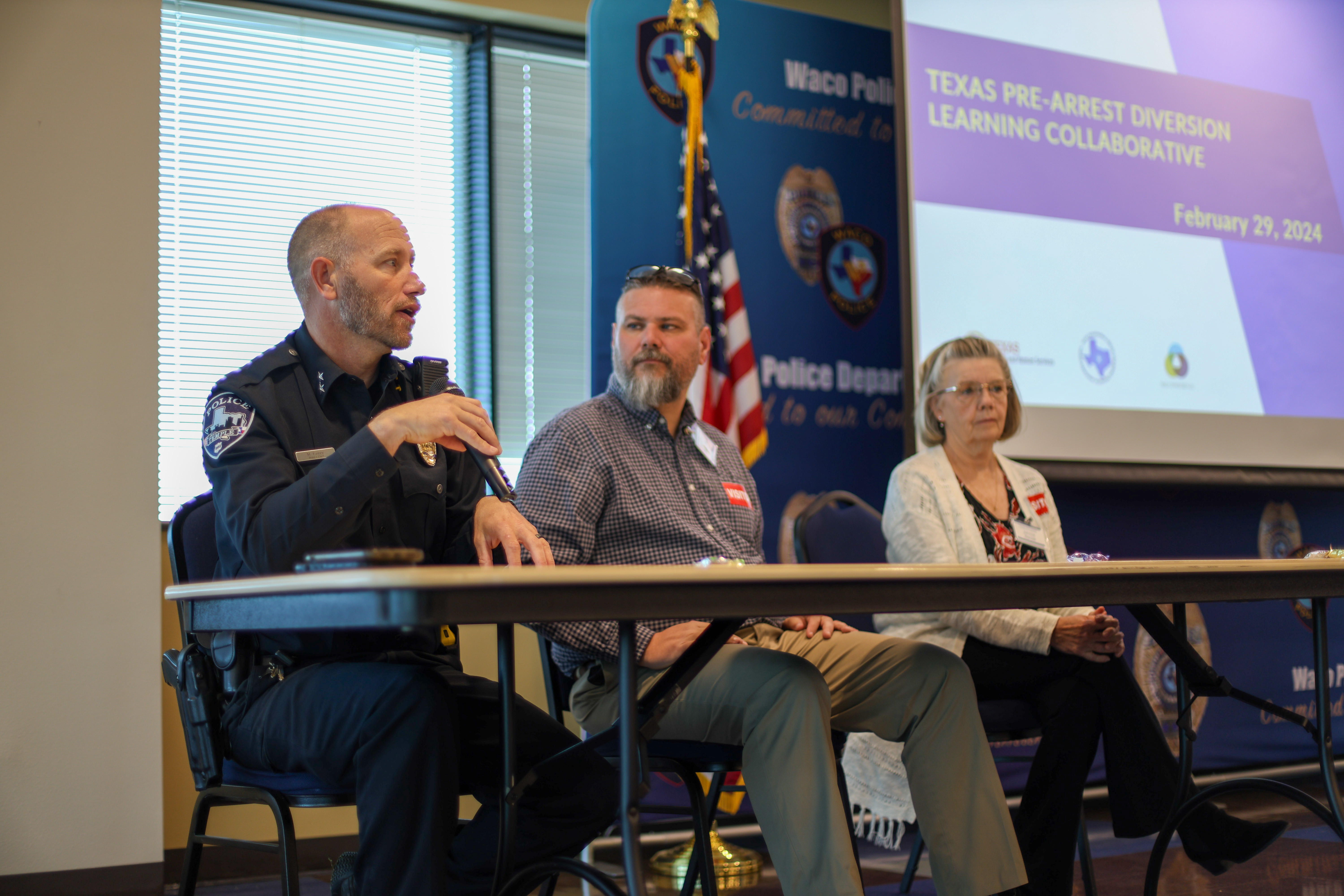 A panel of two men and one woman at the Pre-Arrest Diversion Learning Collaborative meeting.